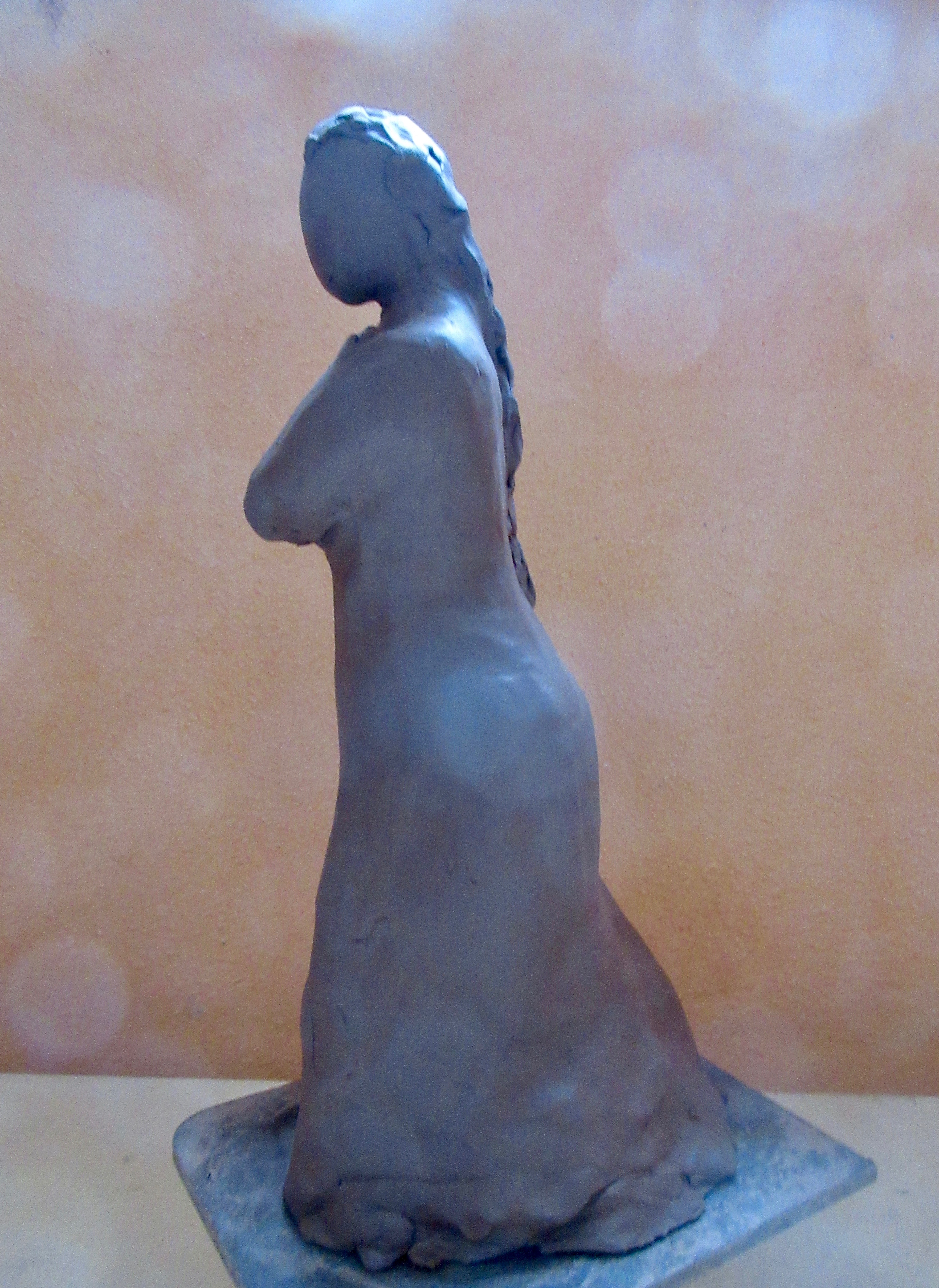 clay figurine of a woman walking