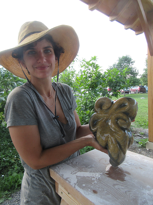Alkion summer program student working on stone carving outdoors