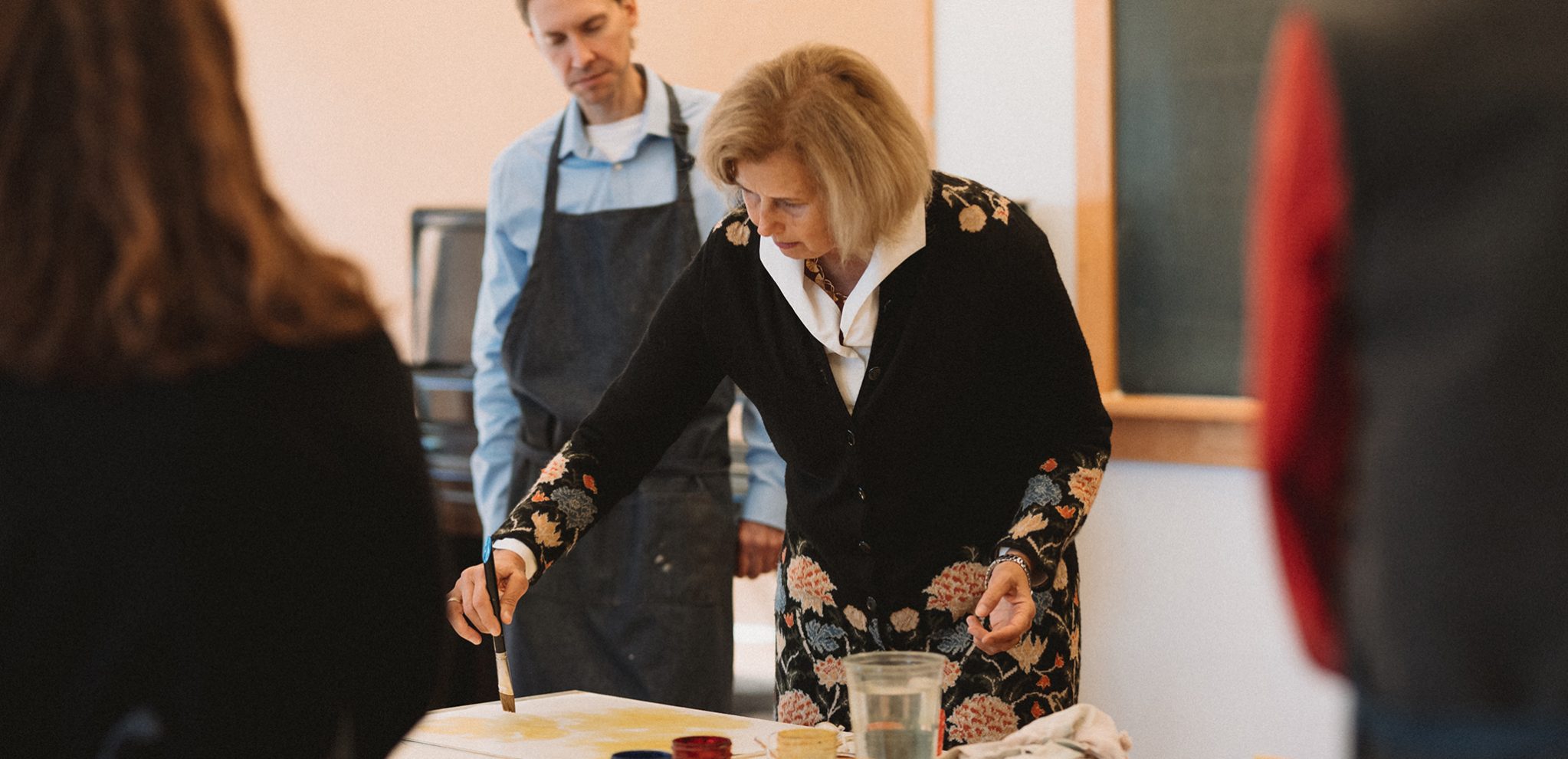 Martina Muller demonstrating painting technique to Alkion class.