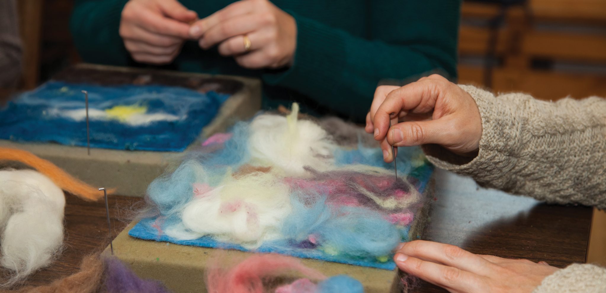 Alkion student's hands felting on foam.